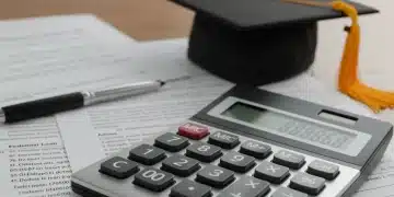 Calculator displaying interest rates, student loan documents, and graduation cap in the US.