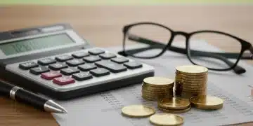 Financial planning tools for retirement, showing calculator, pen, and coins